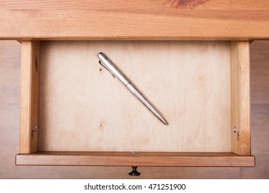 top view of old silver pen in open drawer of nightstand - Shutterstock ID 471251900