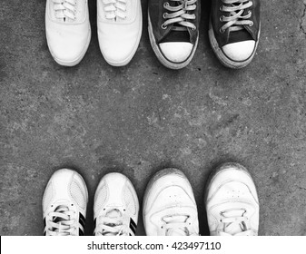 Top View Of Old Sneaker Shoes On Floor Background With Black And White Style