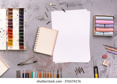 Top view on art workplace. Photo for news or advertising posts, social networks. On table lay stationery items, paints, pencils and easy for creative work artist. - Powered by Shutterstock