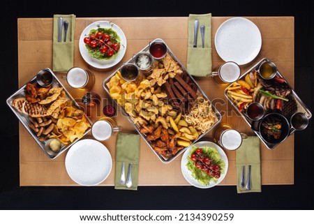 Top view on assorted salty snacks set on the table