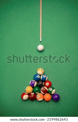 Top view on billiard ball and cue