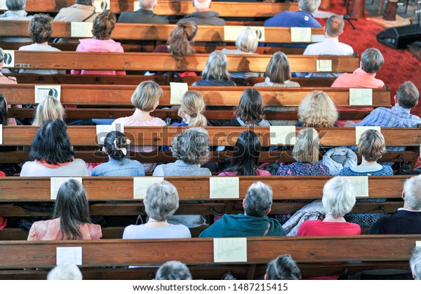 Top view on a Christian\
community at a church service or concert in a church - selective\
focus