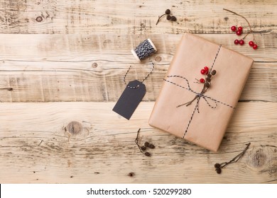 Top View On Christmas Gift Wrapped In Craft And Decorated With Various Natural Things. DIY Present Idea. Holidays Concept.