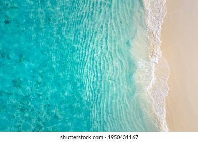 Top View On Coast Waves On Beach Aerial View, Crystal Clear Water. Stunning Summer Landscape, Sunny Tropical Island Shore. Seaside, Idyllic Nature Earth View. Stunning Scenery, Amazing View