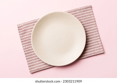 Top view on colored background empty round white plate on tablecloth for food. Empty dish on napkin with space for your design. - Powered by Shutterstock