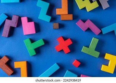 Top view on colorful wooden blocks folding on blue background. Different colorful shapes wooden block.  - Shutterstock ID 2242938419