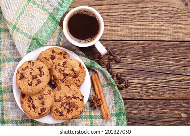 Top View On Cup Of Coffee And Plate With Chocolate Cookies