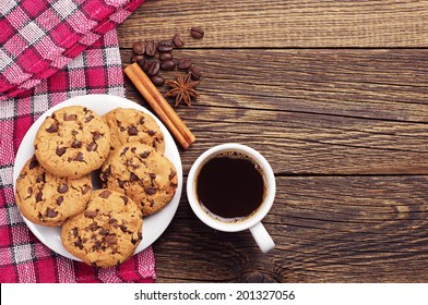 Top View On Cup Of Coffee And Plate With Chocolate Cookies