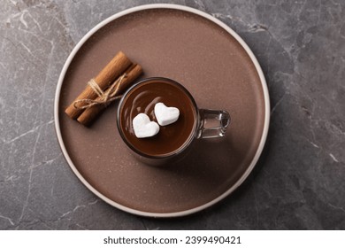 Top view on a cup of hot chocolate with marshmallows on a dark table. 