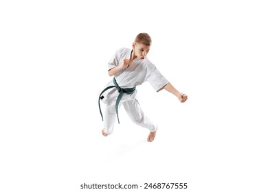 Top view on dedicated young martial artist training, standing in fighting stance isolated on white studio background. Concept of sport, martial arts, combat sport, healthy and active lifestyle - Powered by Shutterstock