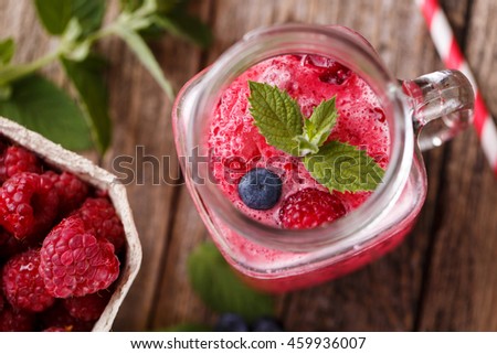 Top view on delicious rasberrie smoothie in glass jar.