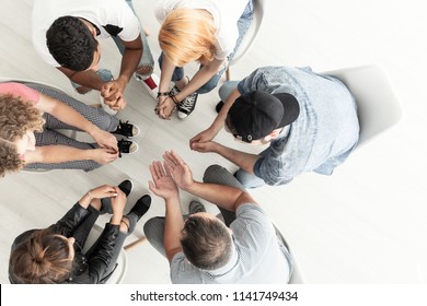 Top View On Difficult Youth Talking To A Therapist While Sitting In A Circle During Meeting