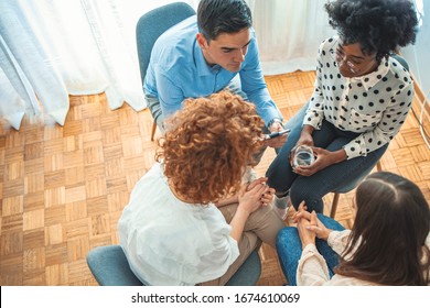 Top View On Difficult Youth Talking To A Therapist While Sitting In A Circle During Meeting. People Participating In Group Therapy For Social Skills Training. Group Therapy