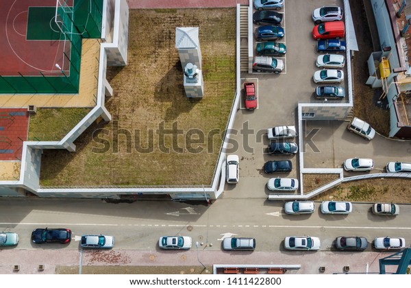 Top\
view on driveways in the residential area with many parked cars.\
Lack of parking places in the city problem\
concept.