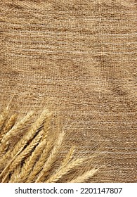 Top view on ears of wheat on the rustic textured burlap table with copy space. Pattern of rye ears on burlap background.  - Shutterstock ID 2201147807