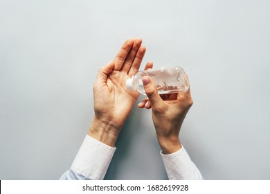 Top view on elegant hands using antiseptic gel to disinfect hands. Precautions during the epidemic. - Shutterstock ID 1682619928