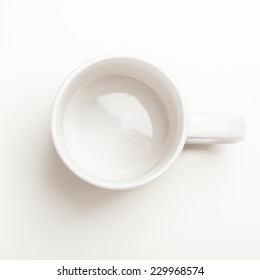 Top View On Empty White Coffee Or Tea Mug Or Cup. Studio Shot From Above On White Background.