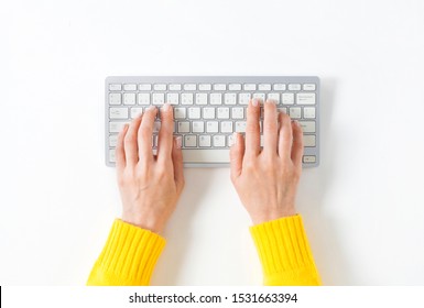 Top view on female elegant hands on a computer keyboard. Isolated white background and clipping path. Simple design, large copy space for your designs - Shutterstock ID 1531663394