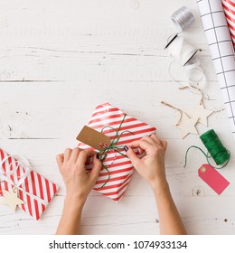 Top View On Girl's Hands Wrapping Christmas Or Birthday Gift. Holiday Season