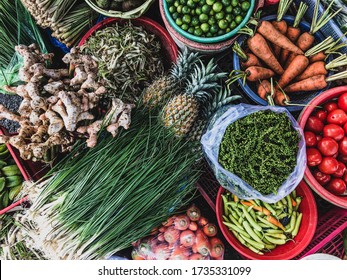 Top view on a large assortment of row loose vegetables and fruits for sale in a street. Short circuit production at Hue Market