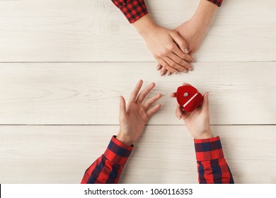 Top View On Male And Female Hands. Man Propose His Woman To Marry Him. Happiness, Relationships, Love, Engagement Concept, Copy Space