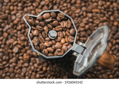 Top View On Mocha Pot Full With Coffee Beans. Coffee Background Concept.