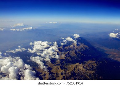Top view on Mountains. Aerial view of mountain landscape. Mountain peak of rocks covered by clouds. Mountain range. mountain chain. Sunrise in mountains with snow ridge. Highest mountains in world