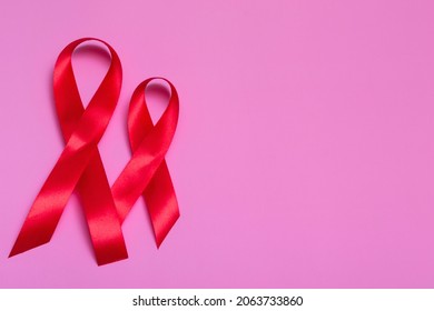 Top View On Pink Background With Red Ribbon Concept December 1st International AIDS Day Close-up.