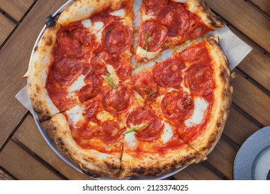 Top View On Pizza With Chorizo - Spicy Pork Sausage, Stracciatella, Tomato Sauce, Green Onion On Wooden Table. Lifestyle Background.