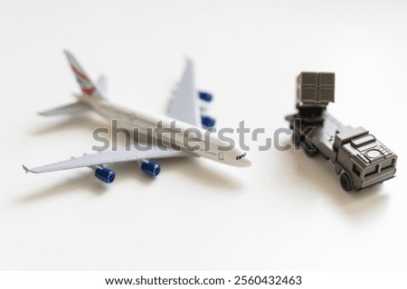 Top view on plastic model military vehicle and aircraft