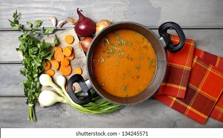 Top View On Pot Of Tomato Soup And Fresh Vegetables On Old Wooden Table