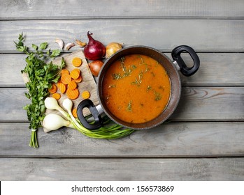 Top View On Pot Of Tomato Soup And Fresh Vegetables On Old Wooden Table