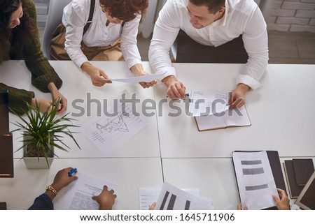 Top view on process of working business people, business meeting, papers on table