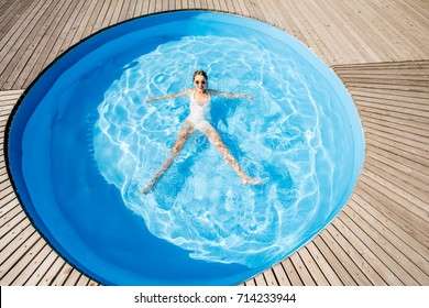 Top View On The Round Water Pool With Woman Swimming Outdoors