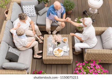 Top View On Senior People Talking During Meeting On The Terrace Of A Nursing House