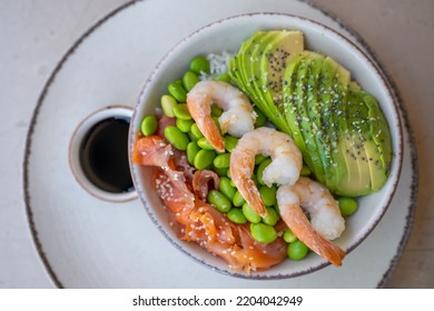 Top View On Shrimp Poke Bowl With Edamame Beans, Avocado, Avocado And Salmon.