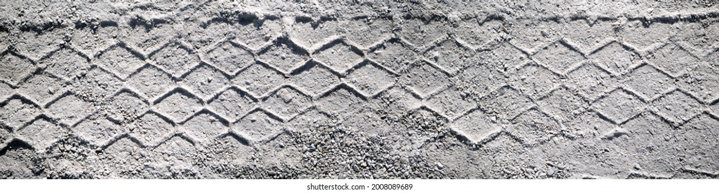 Top View On Tire Track In The Sand. Panorama Of Tire Track, Suitable For Header Or Banner. Off Road Wheel Tracks Under Hard Sunlight.