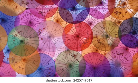 Top view on the traditional colored Chinese sunshade umbrellas. Beautiful Traditional Chinese patterns and ornaments on the colorful wooden and paper umbrellas. Lunar Year decoration. - Powered by Shutterstock