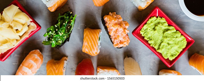 Top View On Traditional Japanese Empty With Sushi, Ginger, Soy Sauce, Wasabi On Concrete Gray Background, Mock Up. Online Food Delivery Concept