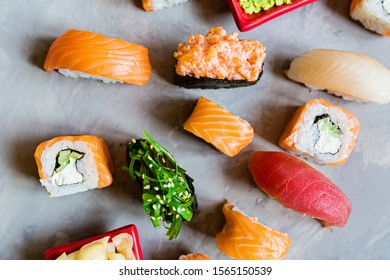 Top View On Traditional Japanese Empty With Sushi, Ginger, Soy Sauce, Wasabi On Concrete Gray Background, Mock Up, Flat Lay. Online Food Delivery Concept