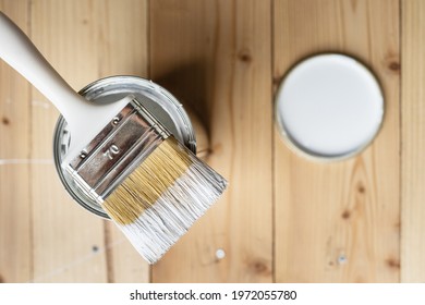 Top View On White Paint Brush On The Opened Can On The Wooden Table Or Floor Painting And Renovation Repairing Concept