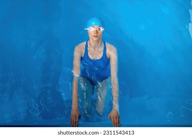 Top view on young sportswoman training backstroke in indoor swimming pool - Powered by Shutterstock