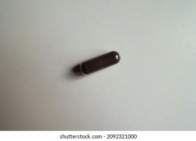 Top View Of One Dark Purple Capsule Of Bilberry Extract Dietary Supplement