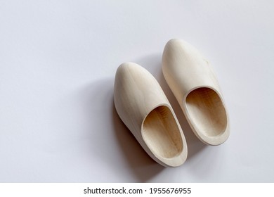 Top view of one pair of typical handmade Dutch wooden shoes on white background with free copy space, Clogs are a type of footwear made in part or completely from wood.