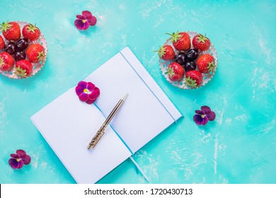 Top View Of Open Blank Notebook, Mock Up Over Blue Desk Background. Wild Berry Fruit Arrangement.strawberries, Concept Of Busy Morning Breakfast, Summer To Do List Planner.