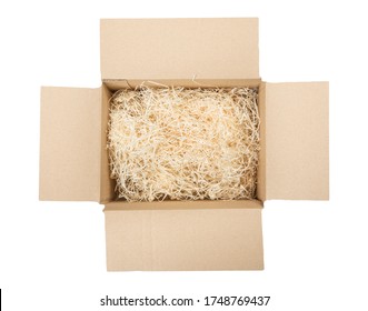 Top view of open cardboard box with shredded wood excelsior for filling inside. Using natural sustainable material for wrapping or products background. Isolated on white, studio shot.