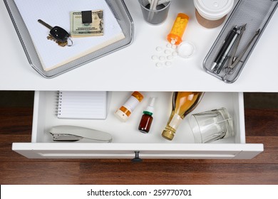 Top view of an open desk drawer showing the items inside. 
