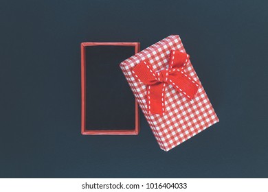 Top View Of Open Empty Gift Box On Black Background. Space For Product Placement. Minimal Concept.