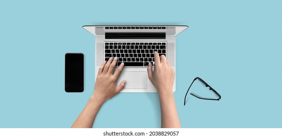 Top view of open laptop with hands typing on keyboard isolated on solid color background. of free space for your copy, view from top. Clipping path.  - Shutterstock ID 2038829057