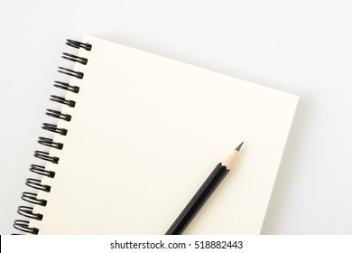 Top View Of Open Spiral Blank Notebook With Pencil On White Desk Background